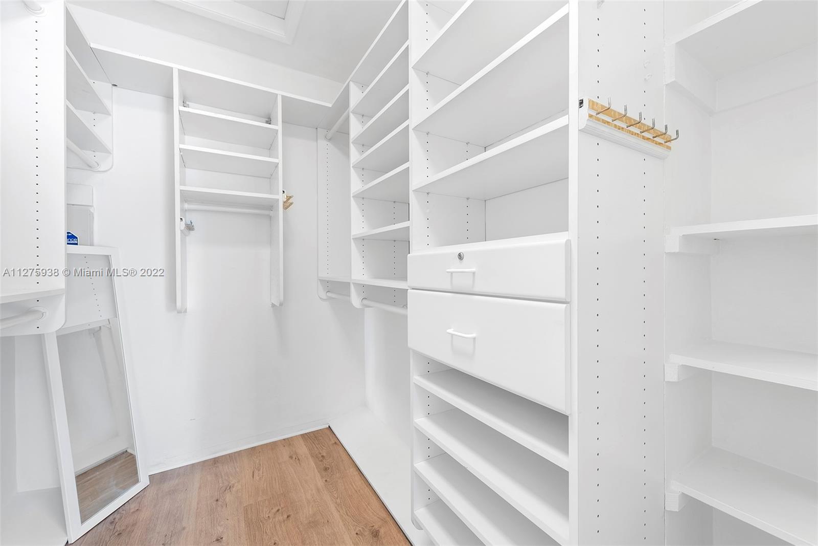 940 88th Street Surfside, FL 33154 - Photo 29 of 38 a view of walk in closet with empty racks