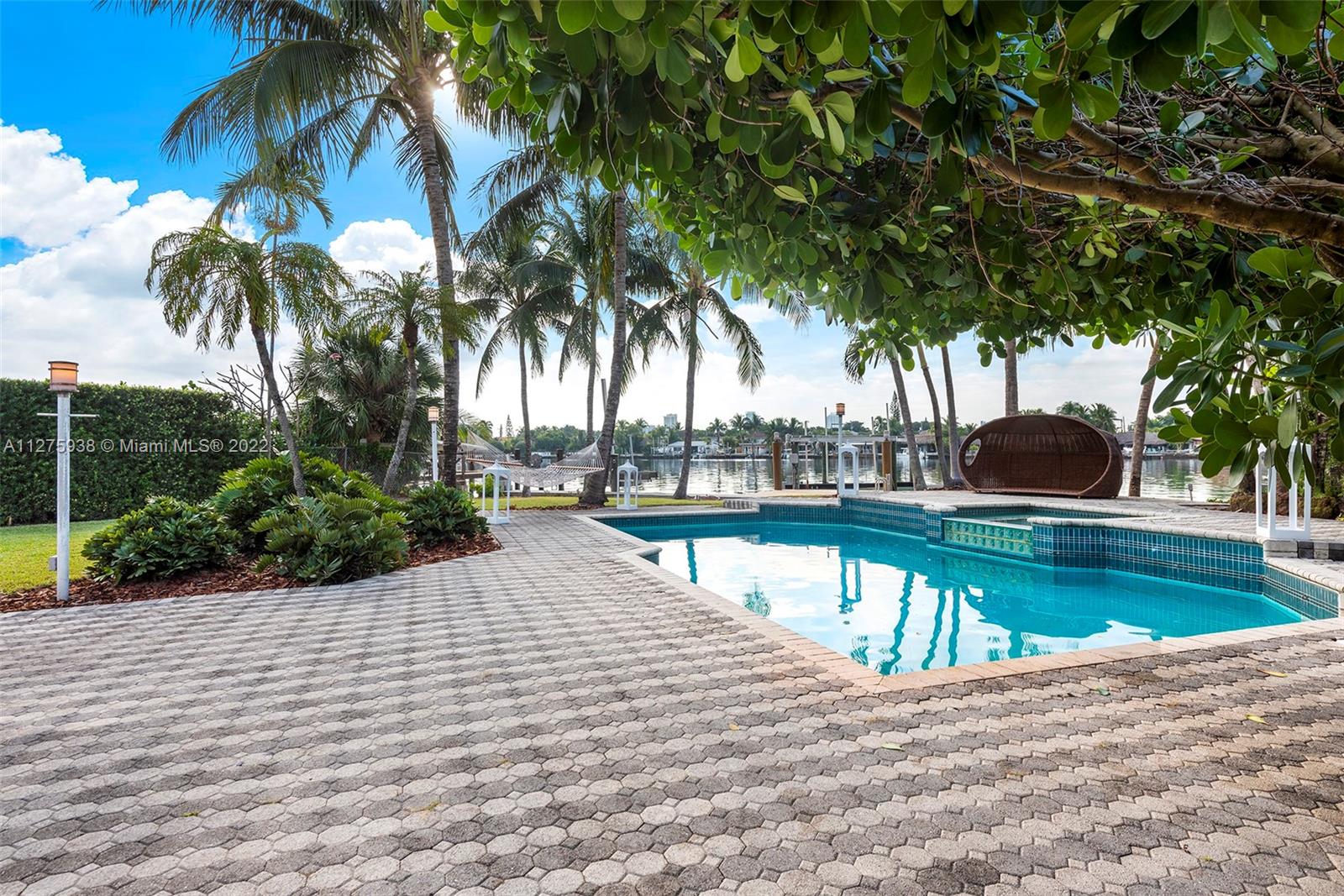 940 88th Street Surfside, FL 33154 - Photo 3 of 38 a view of a swimming pool with a patio