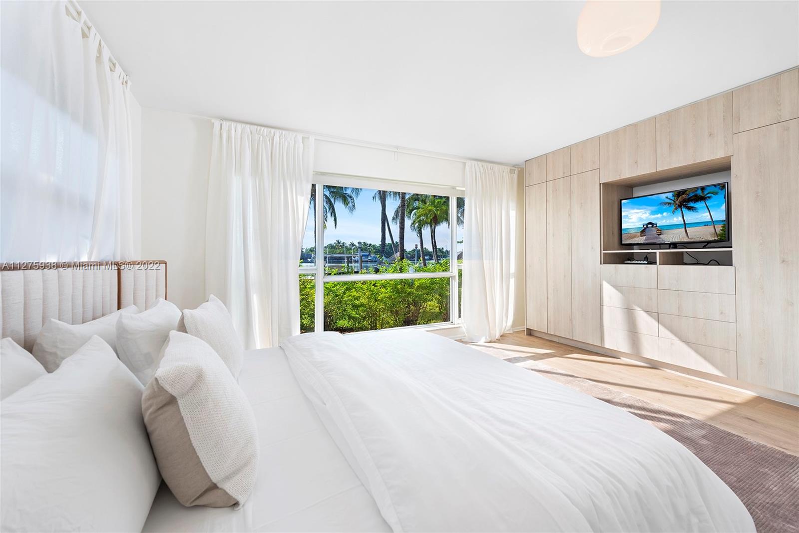 940 88th Street Surfside, FL 33154 - Photo 31 of 38 a bed room with a bed and a television