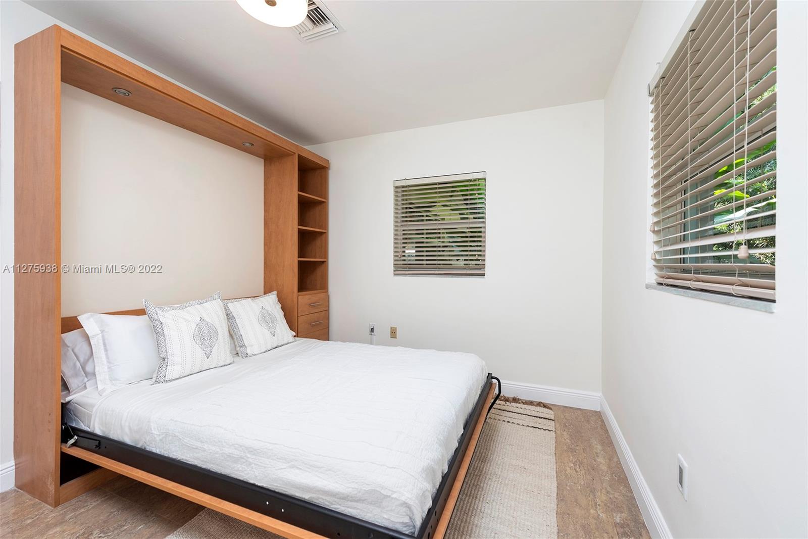 940 88th Street Surfside, FL 33154 - Photo 38 of 38 a bedroom with a bed and a window