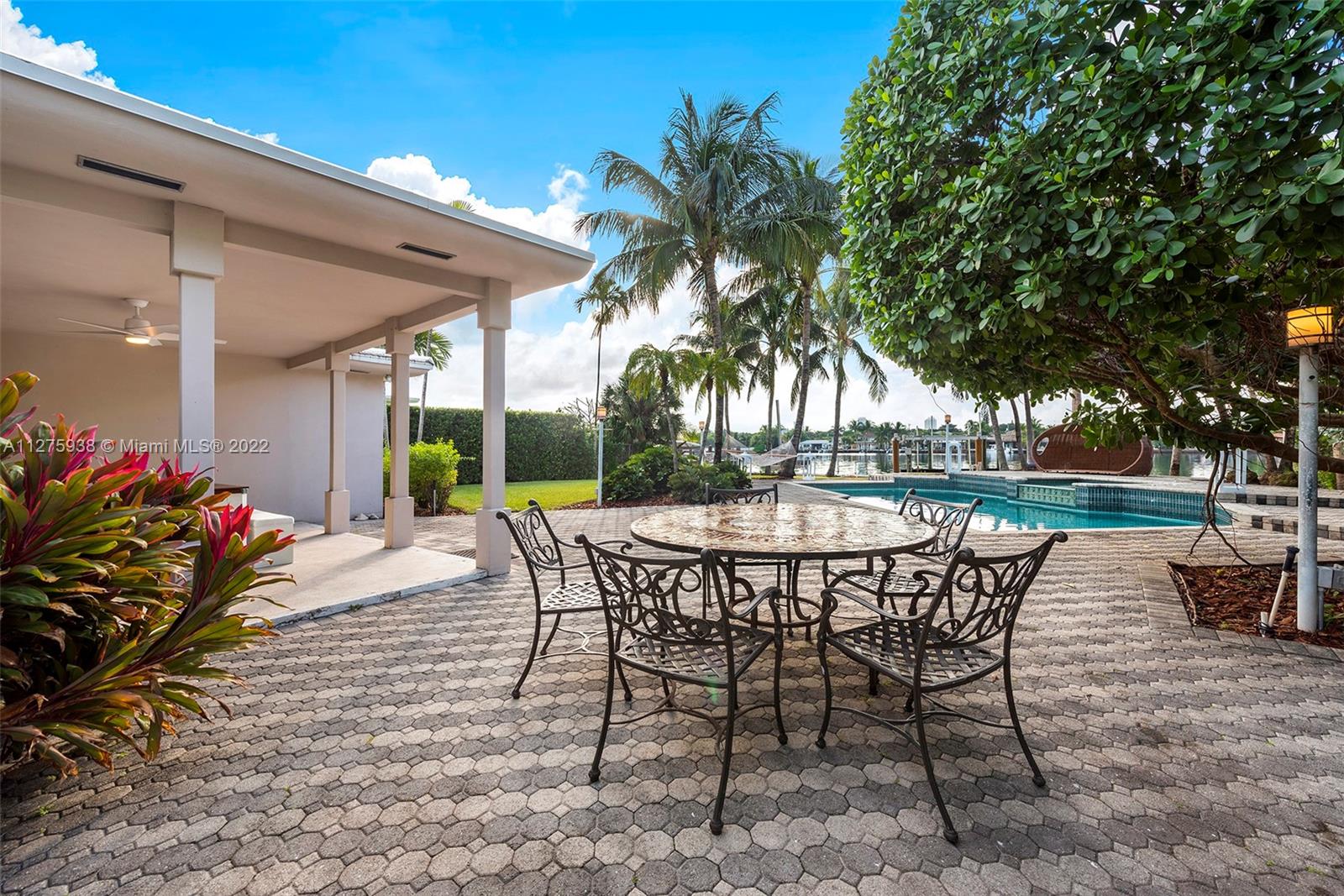 940 88th Street Surfside, FL 33154 - Photo 5 of 38 a patio with table and chairs and potted plants