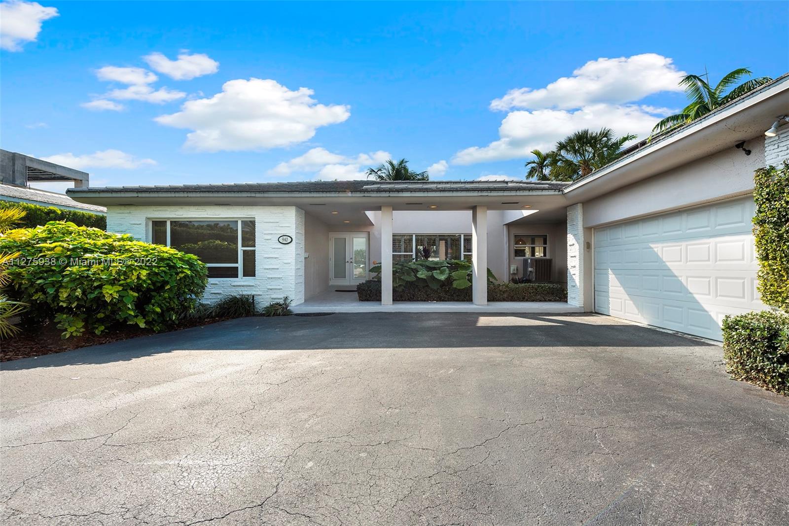 940 88th Street Surfside, FL 33154 - Photo 8 of 38 front view of a house with a yard