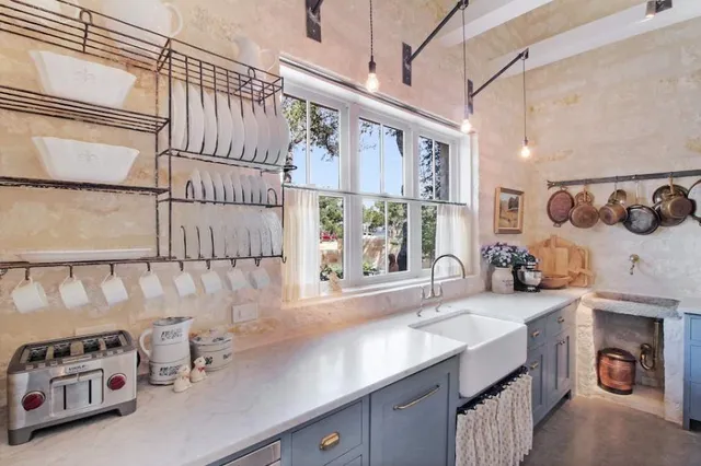 a living room with furniture a table and a fireplace