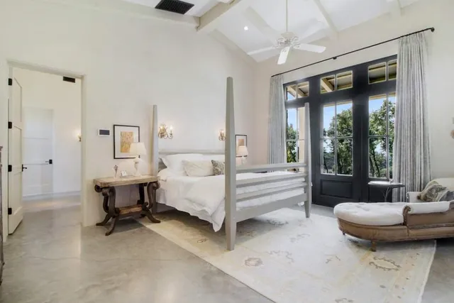 a dining room with lots of furniture and a chandelier