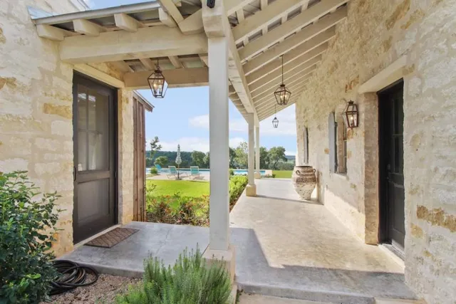 a bedroom with furniture and a large window