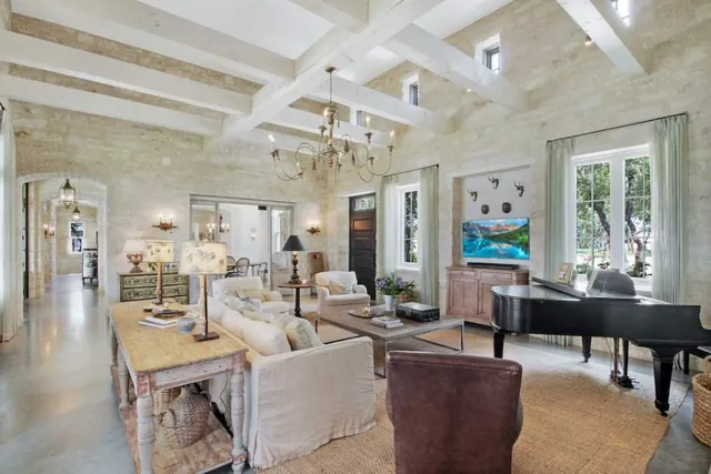 a dining room with furniture a chandelier and wooden floor
