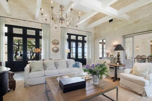 a kitchen with stainless steel appliances a stove a sink a refrigerator and a dining table