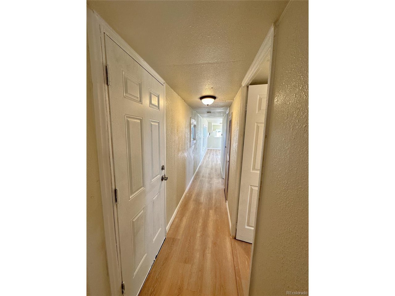 155 Indiana Avenue Limon, CO 80828 - Photo 12 of 27 a view of a hallway with wooden floor