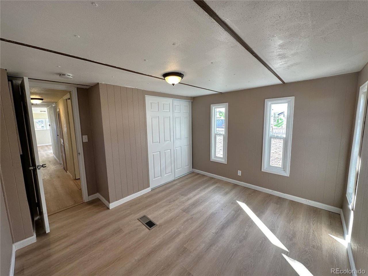 155 Indiana Avenue Limon, CO 80828 - Photo 14 of 27 an empty room with wooden floor and a window