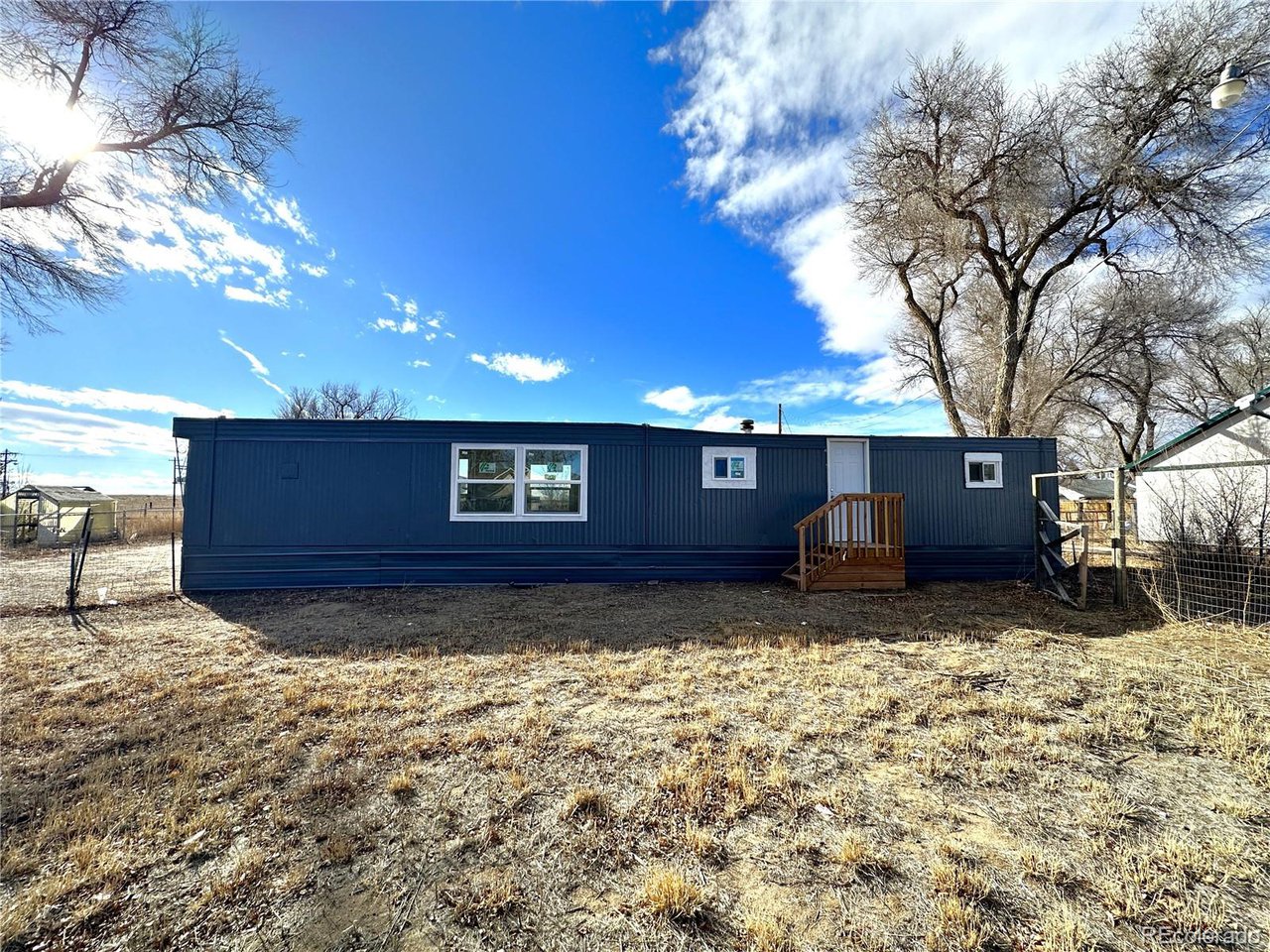 155 Indiana Avenue Limon, CO 80828 - Photo 25 of 27 a view of a house with a yard
