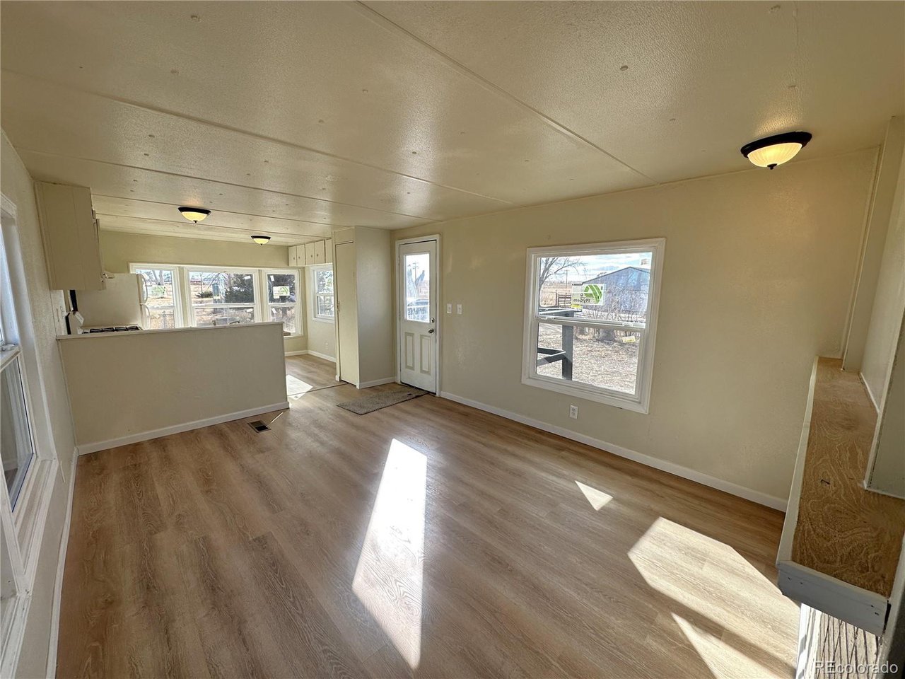 155 Indiana Avenue Limon, CO 80828 - Photo 3 of 27 wooden floor in an empty room with a window