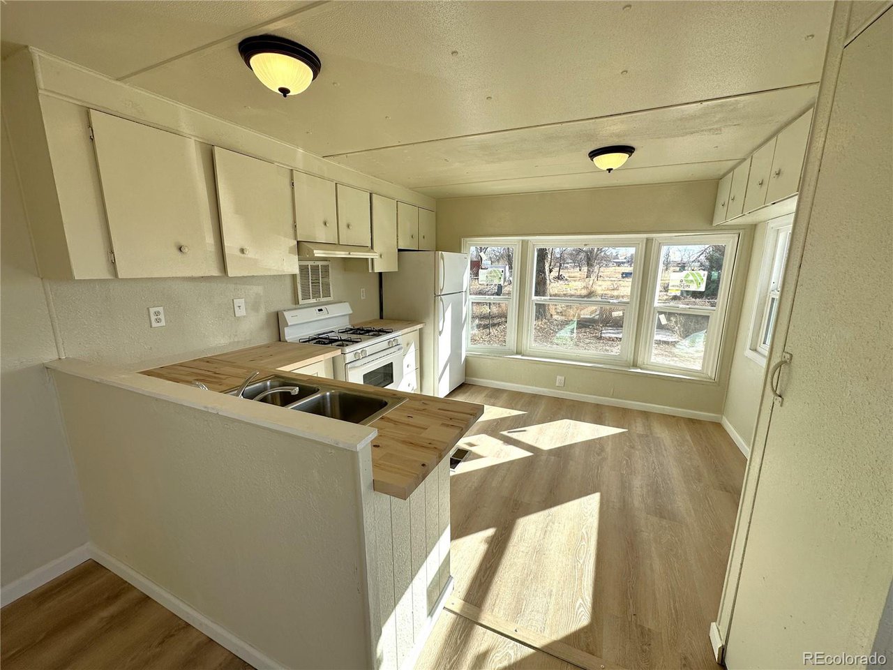 155 Indiana Avenue Limon, CO 80828 - Photo 5 of 27 a kitchen with a stove a refrigerator and a window