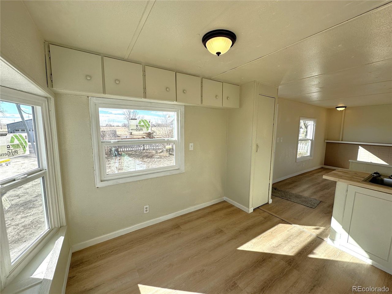 155 Indiana Avenue Limon, CO 80828 - Photo 8 of 27 a view of a kitchen with a window and wooden floor