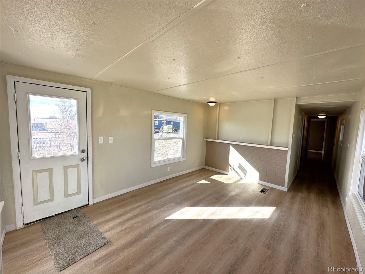 155 Indiana Avenue Limon, CO 80828 - Photo 10 of 27 a view of a livingroom with wooden floor and a window