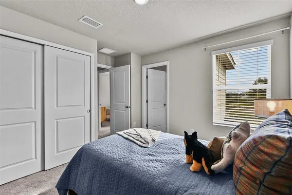 a bedroom with a bed and a window