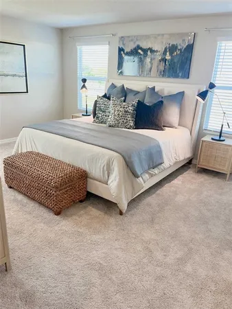 a bedroom with a bed and window