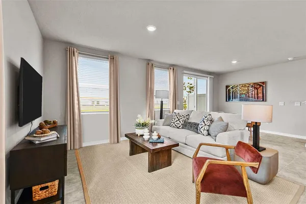 a living room with furniture and a flat screen tv