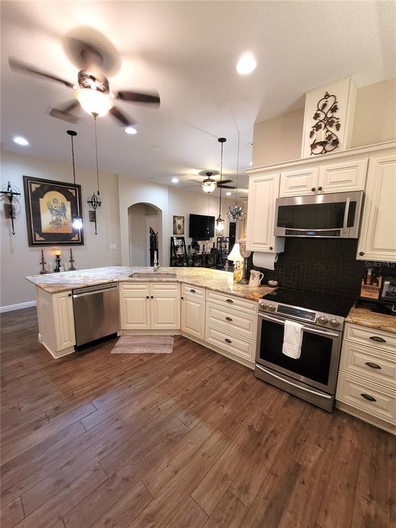 1001 Torreya Way Odessa, FL 33556 - Photo 11 of 44 a large kitchen with stainless steel appliances and a wooden floor