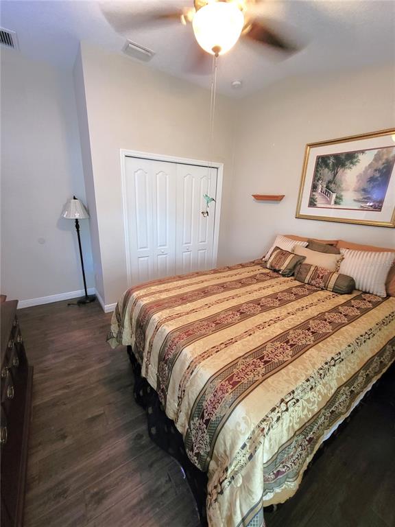 1001 Torreya Way Odessa, FL 33556 - Photo 20 of 44 a bedroom with bed and wooden floor