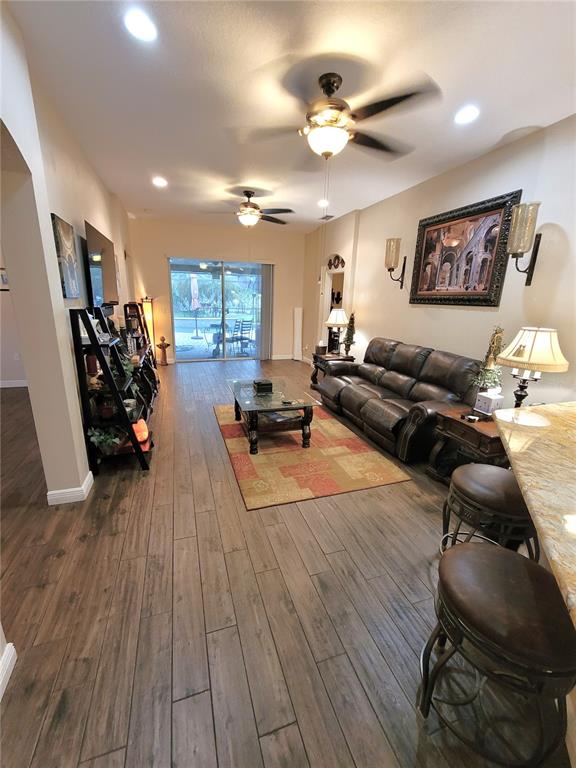 1001 Torreya Way Odessa, FL 33556 - Photo 26 of 44 a living room with furniture and a wooden floor