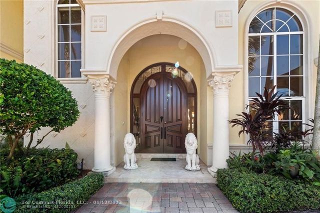 a living room with fireplace furniture and a large window