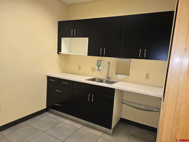 a kitchen with a sink and a mirror