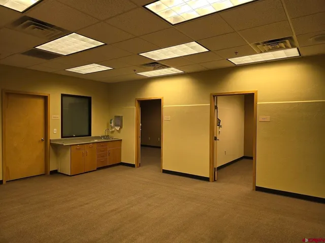 a large white kitchen with a large window