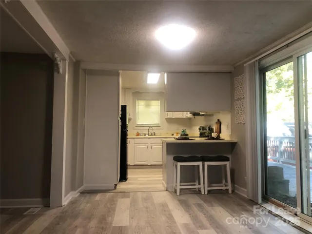 a kitchen with kitchen island a sink stove and refrigerator