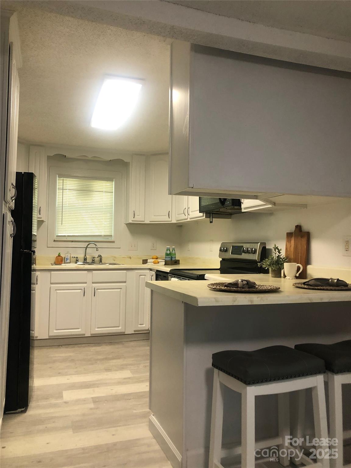 140 Winget Circle Gastonia, NC 28054 - Photo 14 of 16 a kitchen with stainless steel appliances a sink stove and cabinets