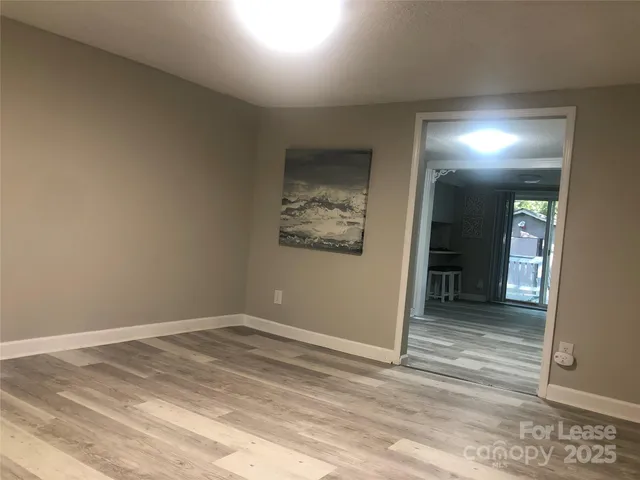 an empty room with closet and mirror