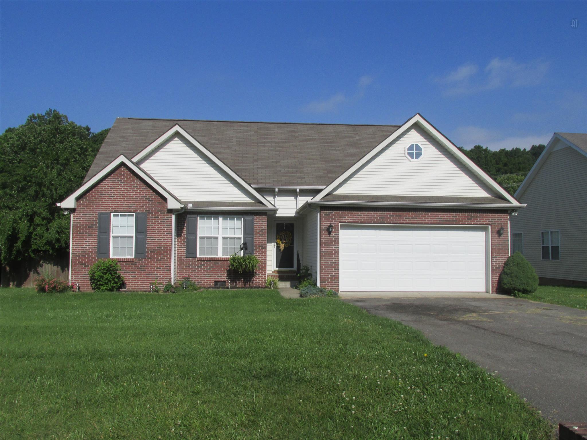 105 Tices Spring Court Dickson, TN 37055 - Photo 1 of 29 a front view of a house with a yard and garage