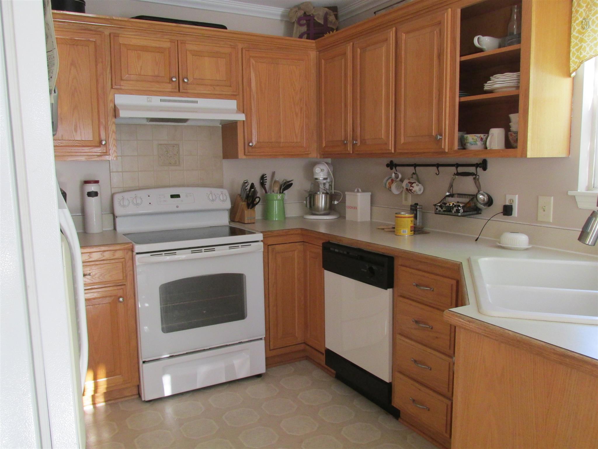 105 Tices Spring Court Dickson, TN 37055 - Photo 6 of 29 a kitchen with granite countertop white cabinets and white appliances
