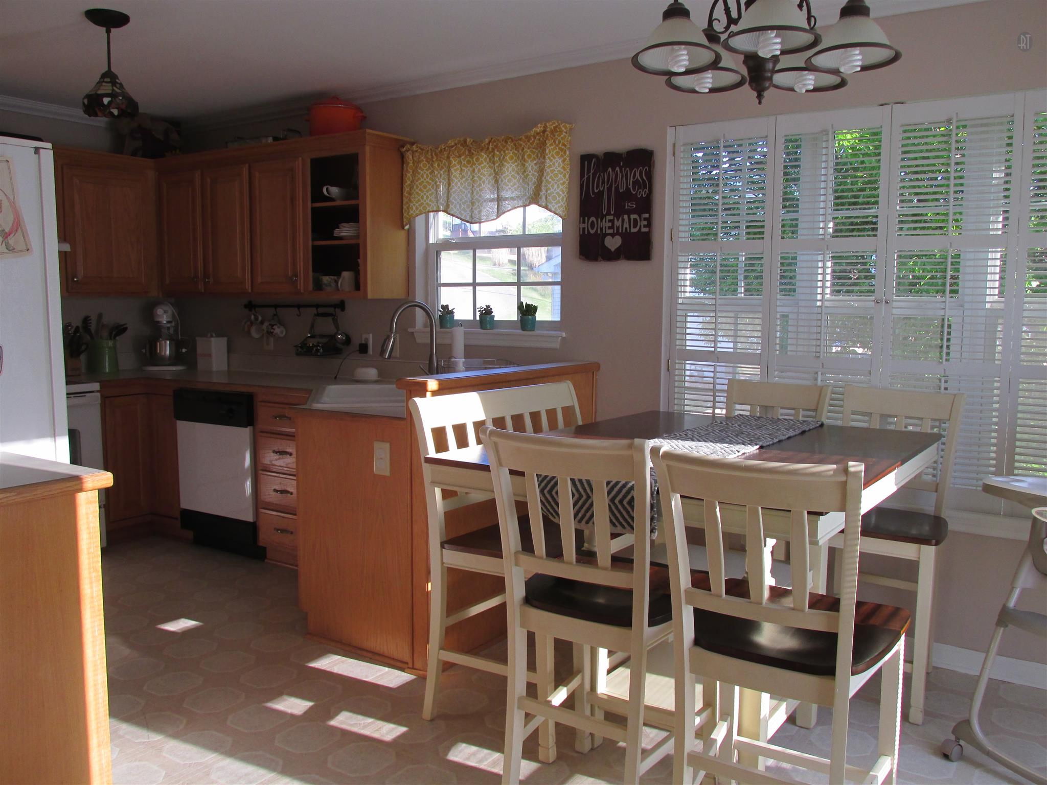 105 Tices Spring Court Dickson, TN 37055 - Photo 8 of 29 a kitchen with stainless steel appliances kitchen island granite countertop a stove a refrigerator a sink a dining table and chairs with wooden floor