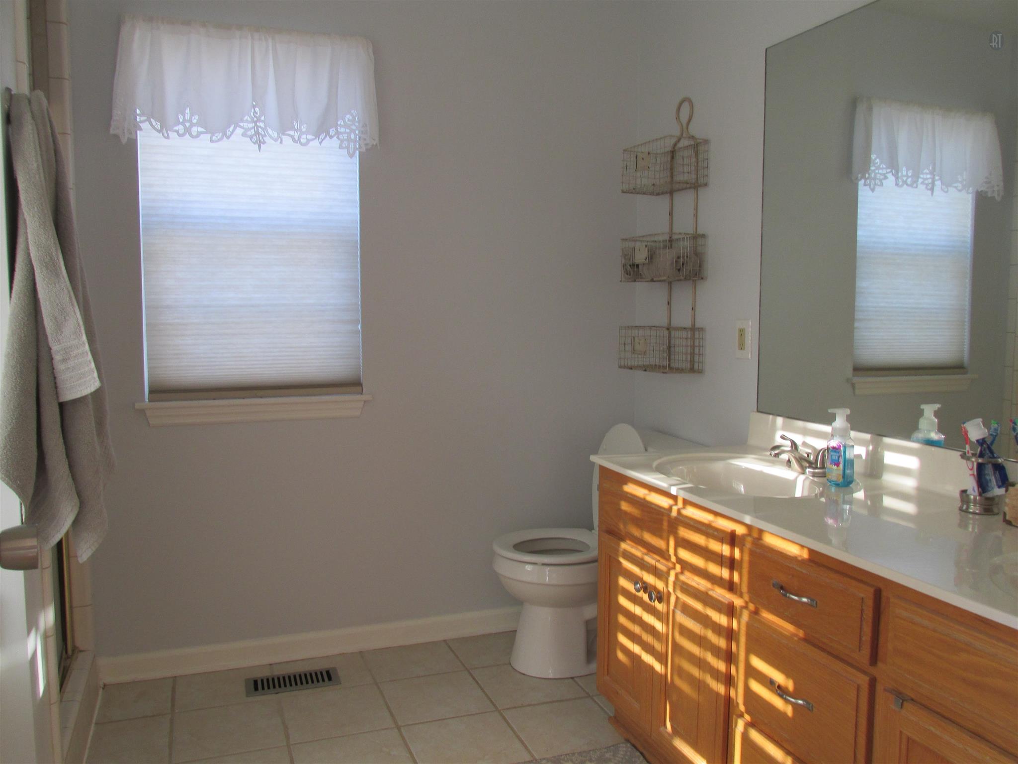 105 Tices Spring Court Dickson, TN 37055 - Photo 10 of 29 a bathroom with a sink a toilet and mirror