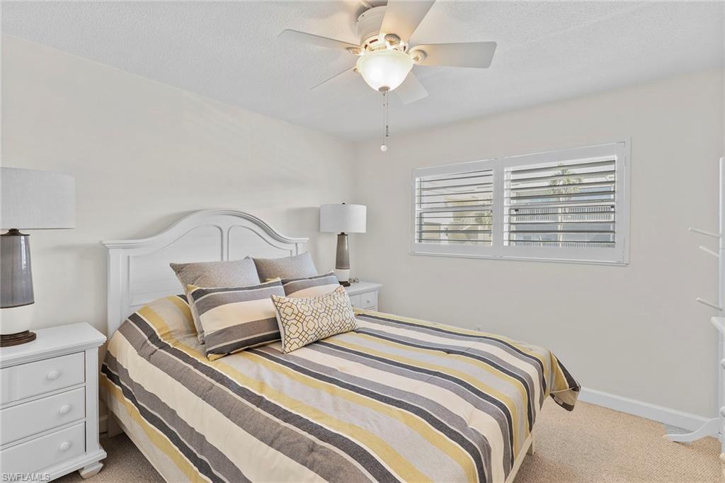 72 7th Street South, Unit 208 Naples, FL 34102 - Photo 11 of 21 a bedroom with bed and a window