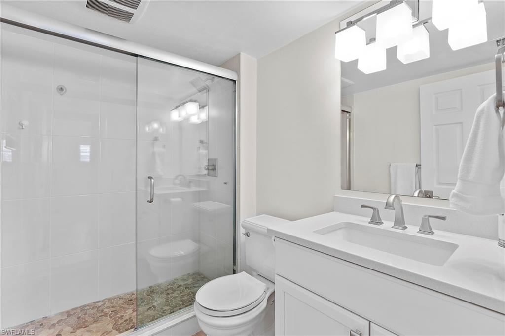 72 7th Street South, Unit 208 Naples, FL 34102 - Photo 14 of 21 a bathroom with a sink a toilet and shower