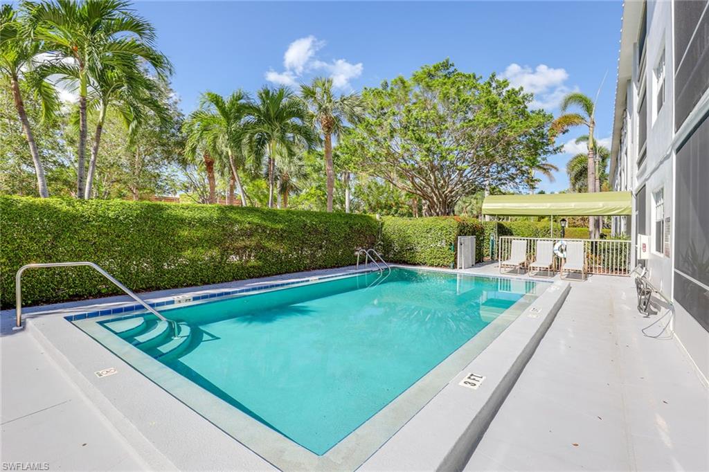 72 7th Street South, Unit 208 Naples, FL 34102 - Photo 20 of 21 swimming pool view with a garden space