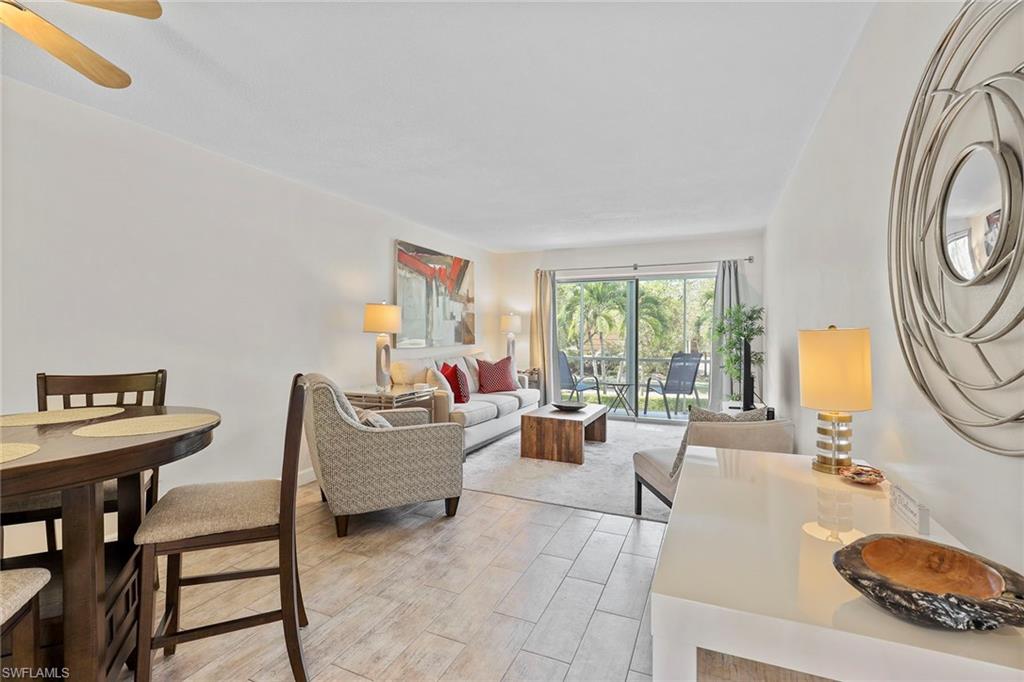 72 7th Street South, Unit 208 Naples, FL 34102 - Photo 4 of 21 a living room with furniture and a large window
