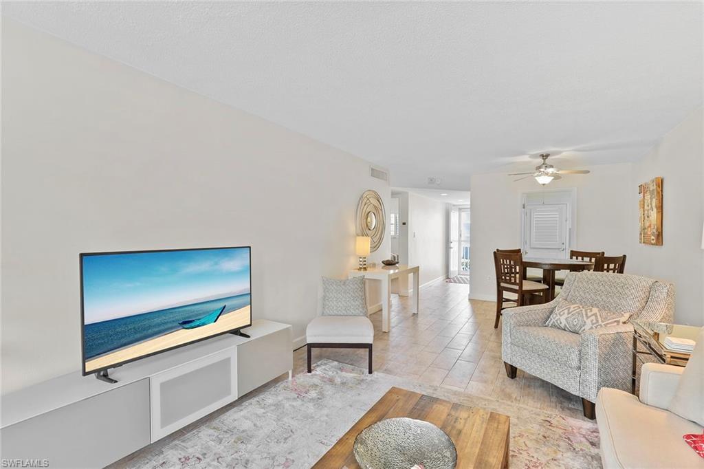 72 7th Street South, Unit 208 Naples, FL 34102 - Photo 6 of 21 a living room with furniture and a flat screen tv