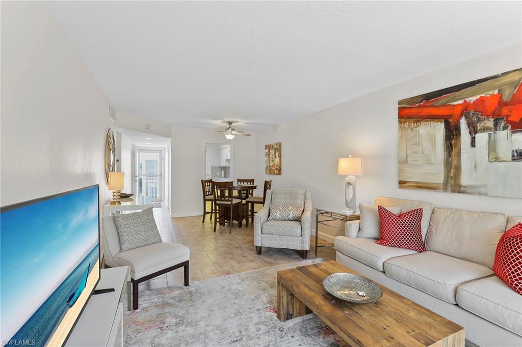 72 7th Street South, Unit 208 Naples, FL 34102 - Photo 7 of 21 a living room with furniture and a large window