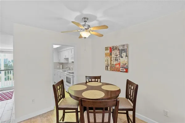 a view of a dining room with furniture and a chandelier