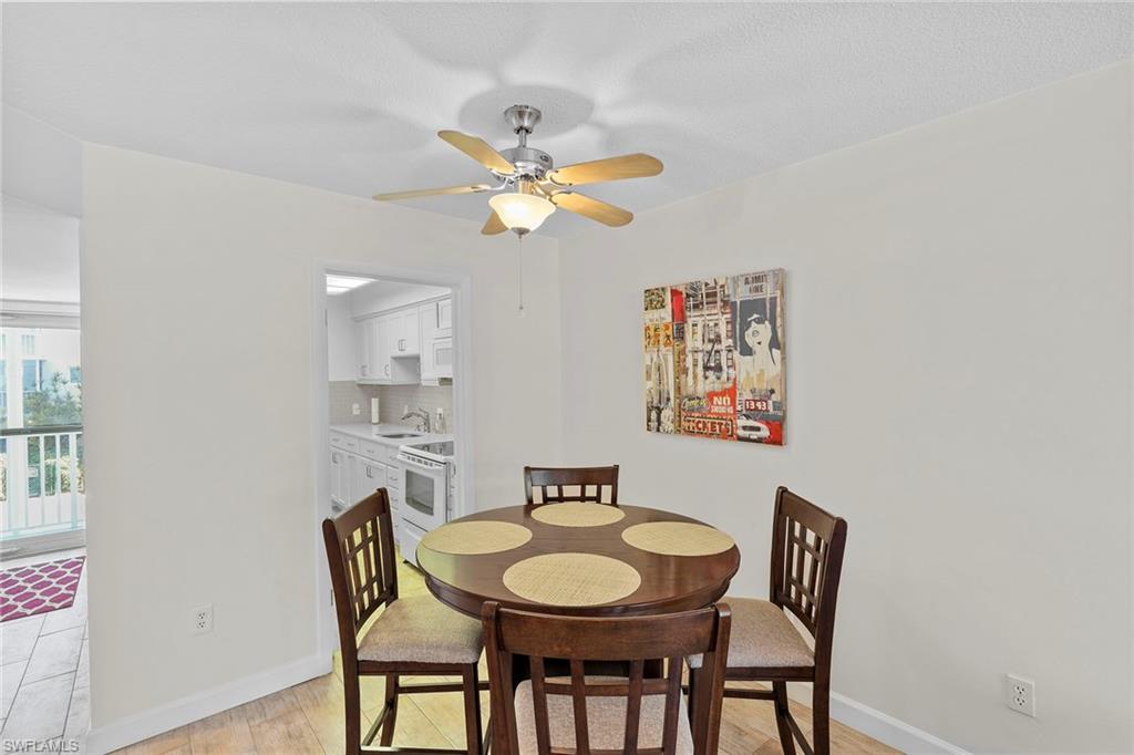 72 7th Street South, Unit 208 Naples, FL 34102 - Photo 8 of 21 a view of a dining room with furniture and a chandelier