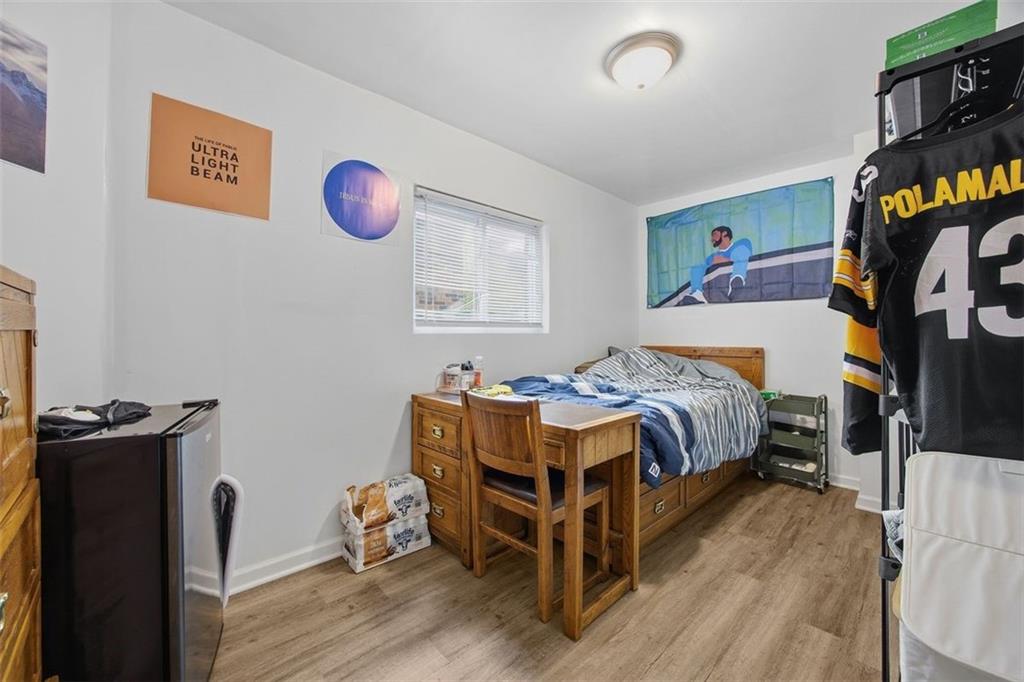 78 South 14th Street Pittsburgh, PA 15203 - Photo 24 of 35 a bedroom with a bed and wooden floor
