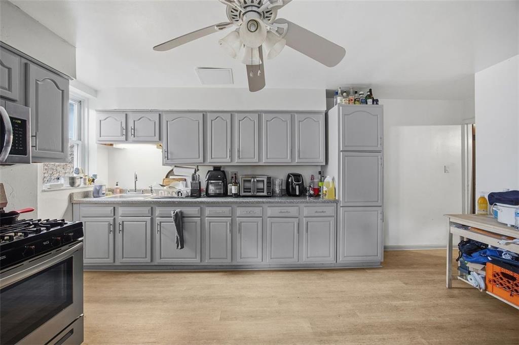 78 South 14th Street Pittsburgh, PA 15203 - Photo 9 of 35 a kitchen with stainless steel appliances granite countertop a stove cabinets and refrigerator