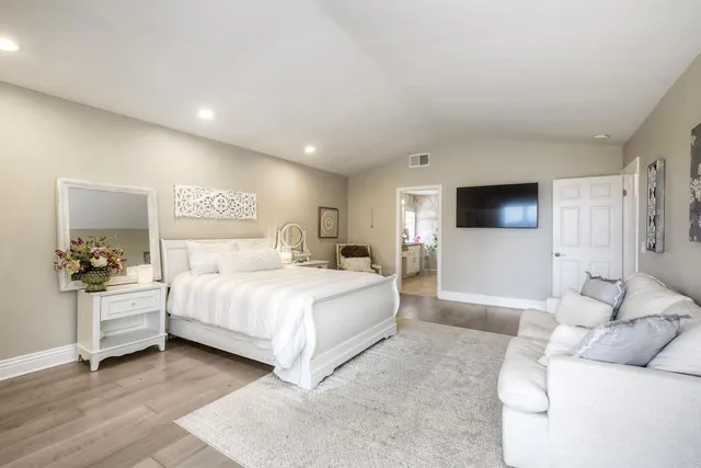 a bedroom with a bed and a couch