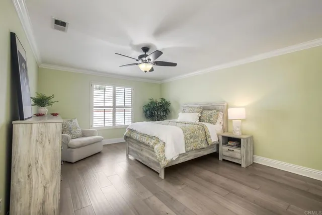 a bedroom with a large bed and white walls