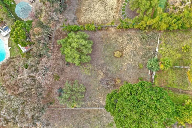 a front view of a house with a garden and yard