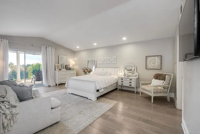 a spacious bedroom with a bed and a couch