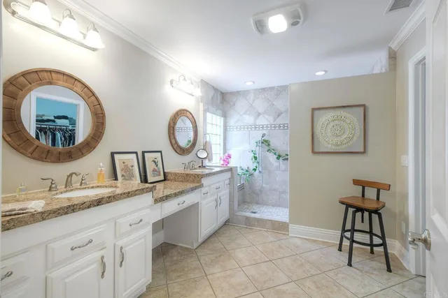 a bathroom with a granite countertop sink mirror and vanity