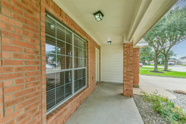 a view of an empty room with a window and a tree